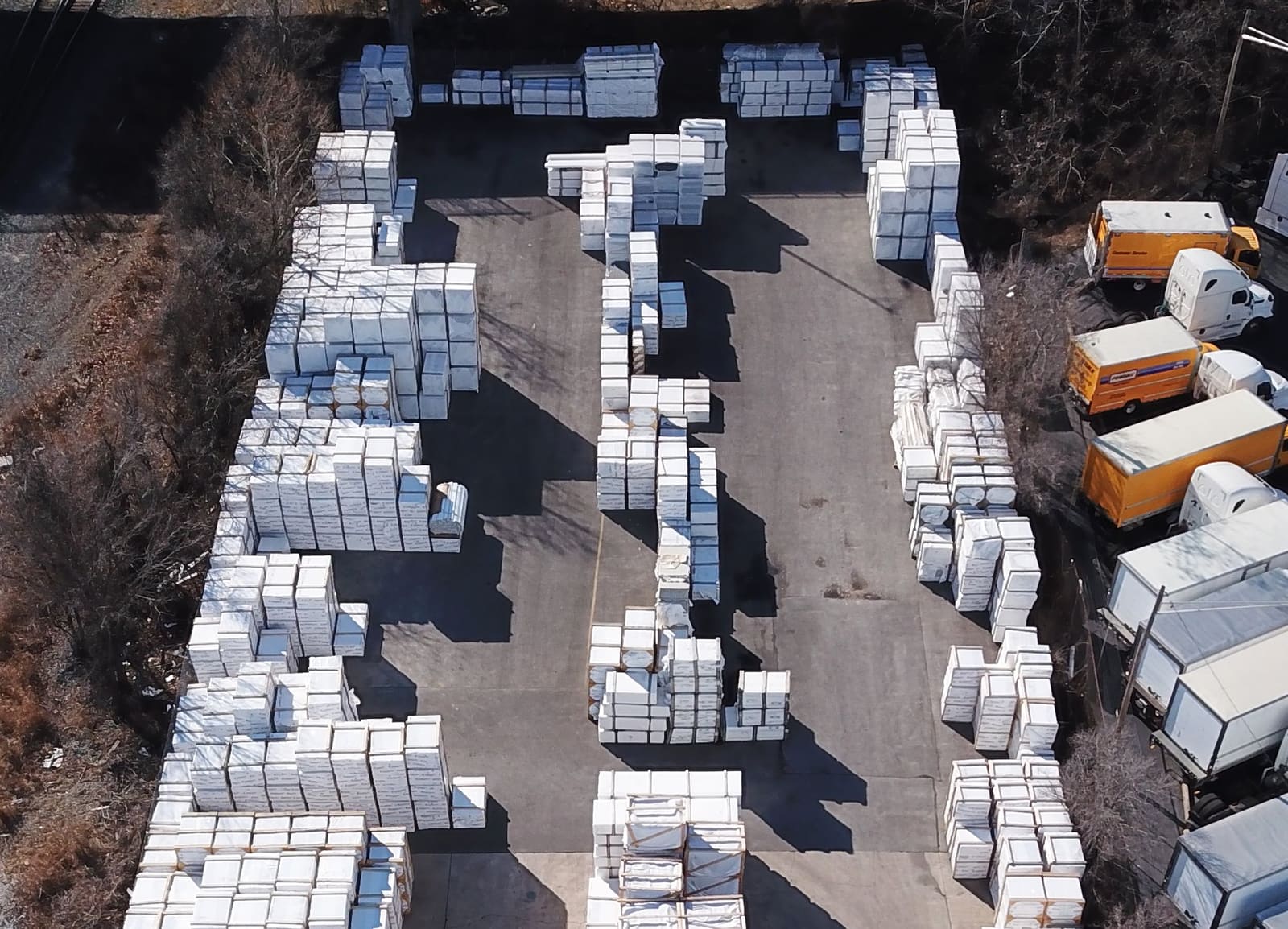 Wrapped fence and rail material staged for pickup, delivery, and freight
